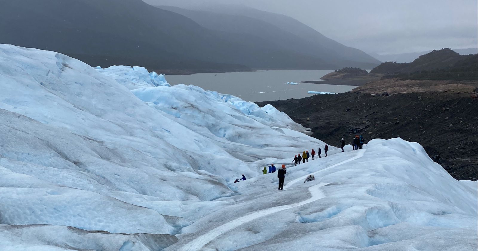 People trekking over Perito Moreno glacier.